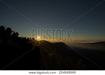People Crown At The Top Of Hill Waiting To See The First Light Of The Day