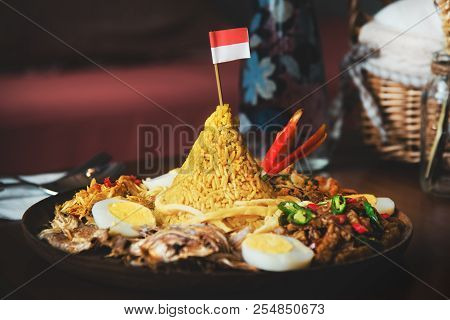 Traditional Indonesian Cuisine Nasi Tumpeng For Independence Celebration With Flag. Tumpeng Is A Con
