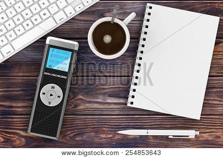 Journalist Digital Voice Recorder Or Dictaphone, Keyboard, Blank Note Pad With Pen And Cup Of Coffee