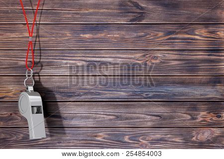 Classic Metal Coaches Whistle Hanging On Red Rope On A Wooden Planks Background. 3d Rendering