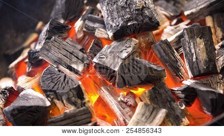 Tview Of Hot Flaming Charcoal Briquettes Glowing In The Bbq Grill Pit. Burning Coals For Cooking Bar