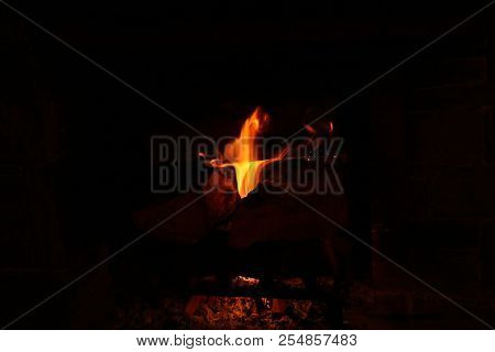 A Dancing Fire In A Fireplace On A Black Background, A Fire Texture, A Red Flame.