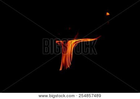 A Dancing Fire In A Fireplace On A Black Background, A Fire Texture, A Red Flame.