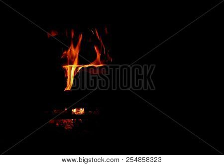 A Dancing Fire In A Fireplace On A Black Background, A Fire Texture, A Red Flame.