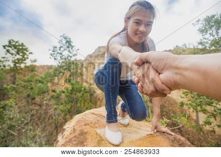 Helping Hand - Hiker Woman Getting Help On Hike Smiling Happy Overcoming Obstacle. Tourist Walking O