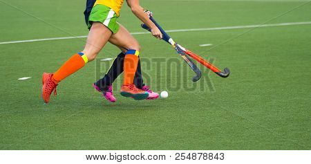 Close Up Of Two Field Hockey Players, Challenging Eachother For The Control And Posession Of The Bal