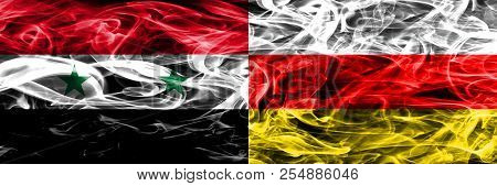 Syria Vs South Ossetia Smoke Flags Placed Side By Side. Thick Colored Silky Smoke Flags Of Syrian An