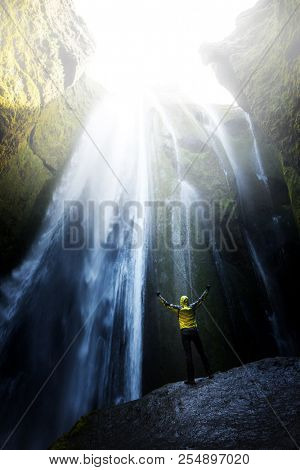 Man in the cave near the Gljufrabui waterfall, Iceland, Europe