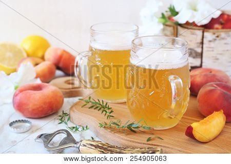 Two Mug Of Light Fruit Craft Beer And Fruits