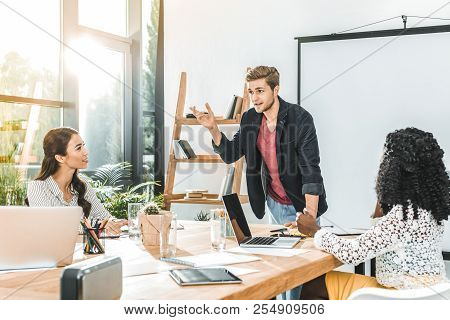 Multiethinc Business Coworkers Having Conversation During Conference In Office