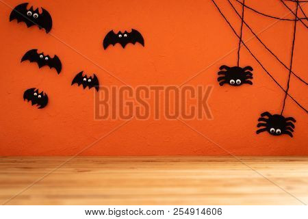 Halloween Crafts, Bat, Spide And Cobweb On Orange Background With Copy Space For Text On Wooden Tabl