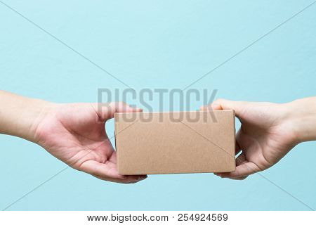 Woman Hand Received The Borwn Box Delivery From Freighter Background With Copy Space