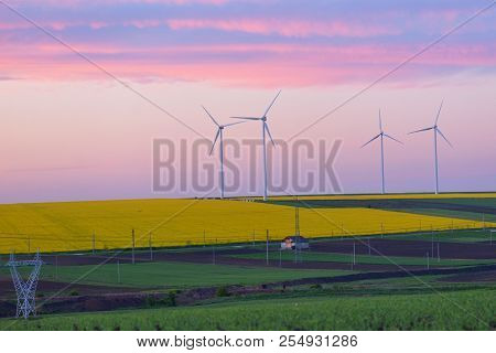 Eolian Field And Wind Turbines At Sunset