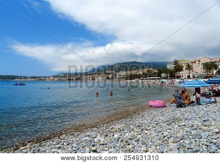 Menton, France - June 30, 2018: Menton Beach And A Panoramic View Of The City. Unidentified People R