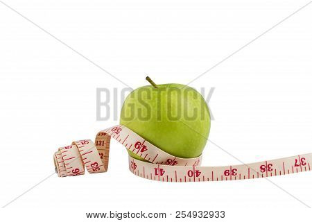 Isolate Green Apple On White Bakcground With Measuring Tape Around. The Heathy Fruit For People Who 