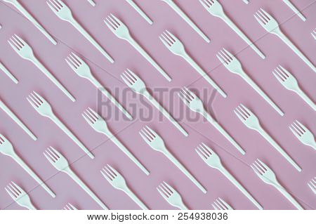 Flay Lay Photo Of White Plastic Disposable Forks. Creative Top View Pattern.