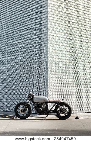 Caferacer Motorcycle Parking Near Wall Of Finance Building. Everything Is Ready For Having Fun Drivi