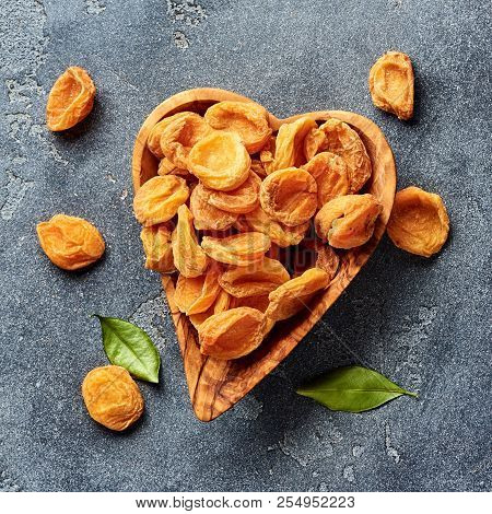 Dried Apricots On Gray Concrete Background. Top View.