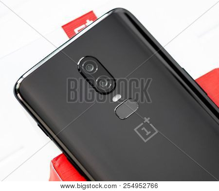 Khakiv, Ukraine - 14 August 2018: Smartphone OnePlus 6 on the white and red box and wooden table