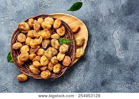 Sun Dried Apricots On Gray Concrete Background. Top View.