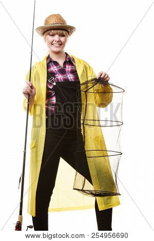 Spinning, Angling, Cheerful Fisherwoman Concept. Happy Woman In Yellow Raincoat Holding Fishing Rod 