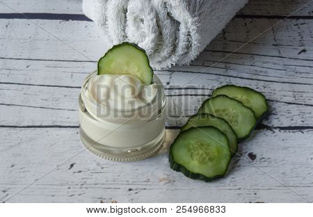Homemade Cucumber Face Cream With White Towel On A White Wooden Background, Homemade Cosmetics