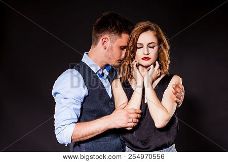 Young Man Sorrowly Holding Woman In His Arms