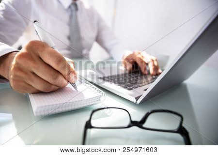 Businessman's Hand Writing In Diary