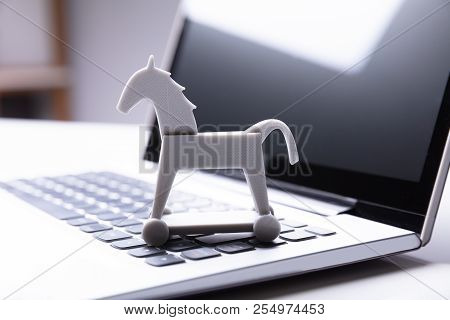 Close-up Of Trojan Horse Icon On Laptop Keypad
