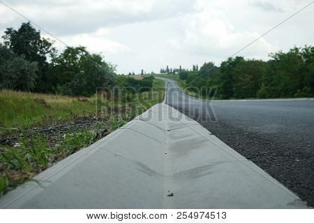 New Roadbed And Stormwater Drainage. Stormwater Drainage For Drainage Of Rain Water Along The Roadwa