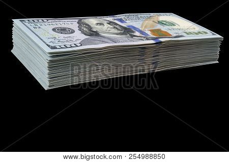 Stack Of One Hundred Dollar Bills Isolated On Black Background. Stack Of Cash Money In Hundred Dolla