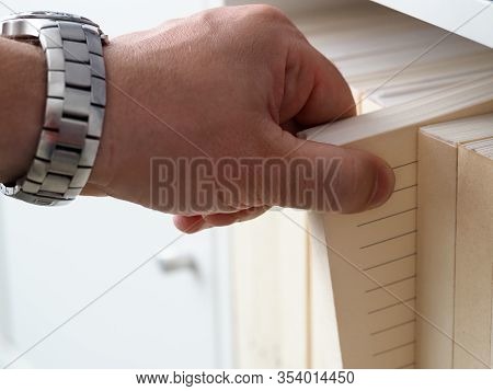 Mans Hand In Watch Pulls Paper From Pile Archive. Optimization Process Acquisition Packs. Prints Sec