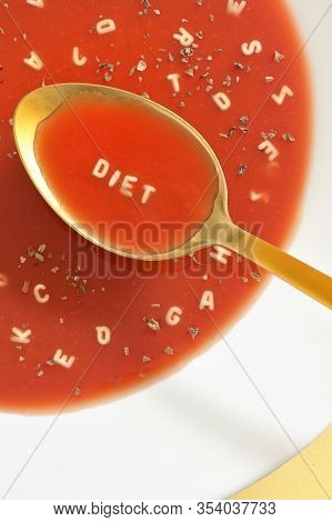 Tomato Soup With Letter Noodles On Spoon