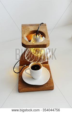 Creative Art Handmade Lamp Made Of Drip Coffee Station, V60 Dripper And Lights. Cup Of Black Coffee 