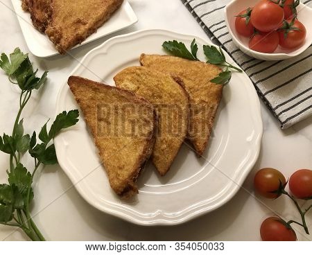 Crispy, golden french toast. Sliced white bread coated in beaten eggs and milk and fried.