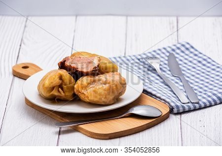 Cabbage Rolls With Meat, Rice And Vegetables In A White Plate On A Wooden Table. Stuffed Cabbage Lea
