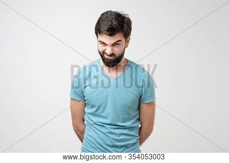 Serious Young Hispanic Man With Raised Eyebrow Having Doubts Or Distrust.