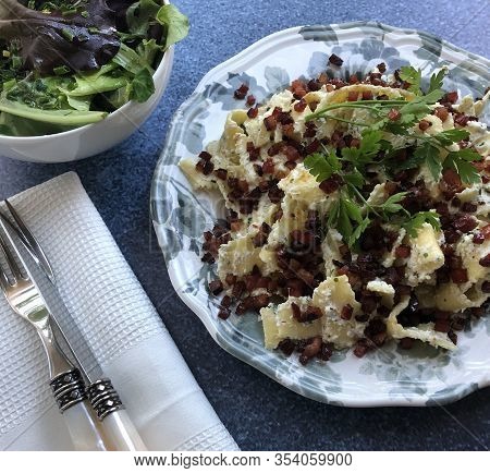 Classic Hungarian Noodle Specialty. Ribbon Pasta With Crispy Bacon, Curd Cheese And Sour Cream.