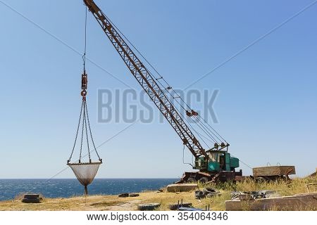 A Crane For Lifting Fishing Gear Stands On A High, Steep Beach. Fishing Camp On Cape Atlesh. Tarkhan