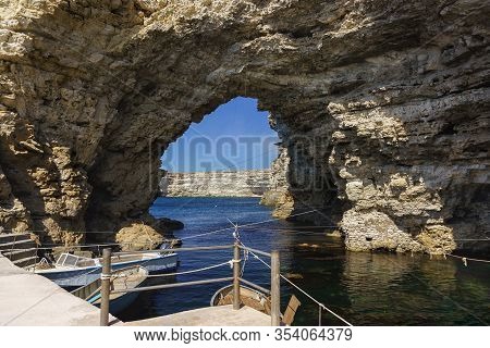 A Picturesque Grotto, And A Pier On Cape Big Atlesh. Fishing Boats On The Clear Water Of The Black S