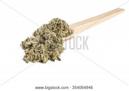 Dried Artichoke Leaves Or In Latin Cynarae Folium In Wooden Spoon Isolated On White Background. Medi