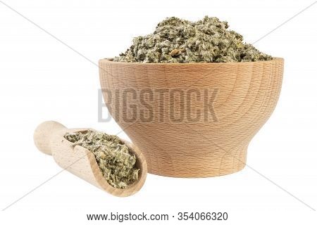 Dried Artichoke Leaves Or In Latin Cynarae Folium In Wooden Bowl And Scoop Isolated On White Backgro