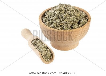 Dried Artichoke Leaves Or In Latin Cynarae Folium In Wooden Bowl And Scoop Isolated On White Backgro