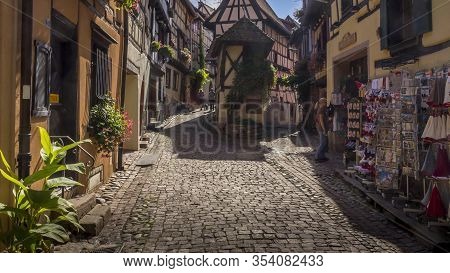 Eguisheim / Alsace, France - 16 Sep. 2015: Beautiful View Of Charming Street Scene With Colorful Hou