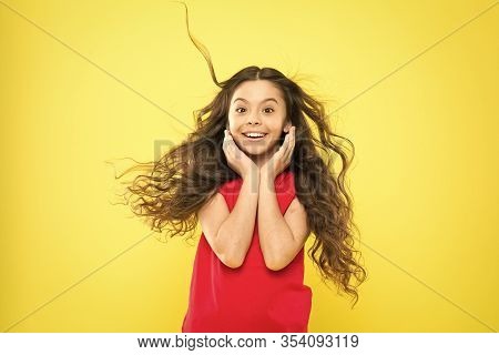 Things You Doing To Damage Your Hair. Girl Adorable Kid Long Wavy Hair Yellow Background. Wind Can A