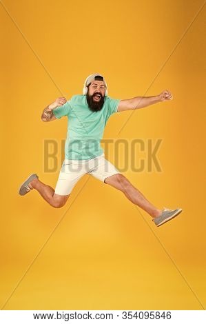Energy Of Rhythm. Music Library. Music Fan. Man Listen Music Wireless Headphones In Motion. Bearded 