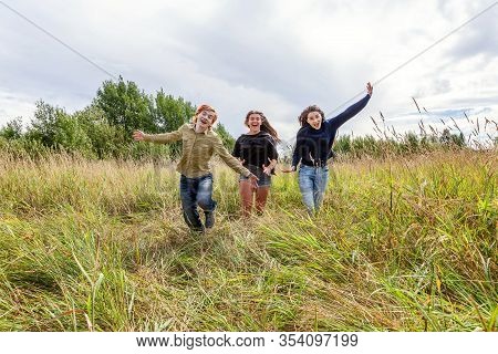 Summer Holidays Vacation Happy People Concept. Group Of Three Friends Boy And Two Girls Running And 