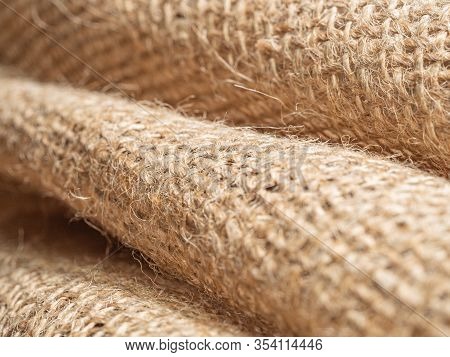 Brown Crumpled Sackcloth, Close Up View, Abstract Background. Texture Of Brown Burlap Textile. Brown