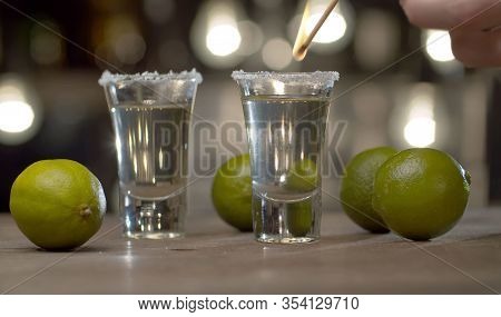 Bartender Pouring Tequila Into Stemware