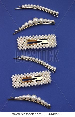 Pearl Hair Clips.fashionable Hair Accessories. Hairpin With White Pearls On A Bright Blue Background